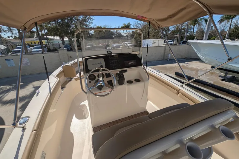 Slide: The Image of 2019 Scout 215 XSF boat interior with steering wheel and Garmin navigation system. - 18