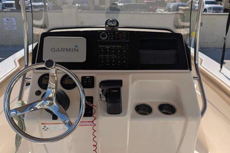 Slide: The Image of 2019 Scout 215 XSF boat dashboard with Garmin navigation system and steering wheel. - 19