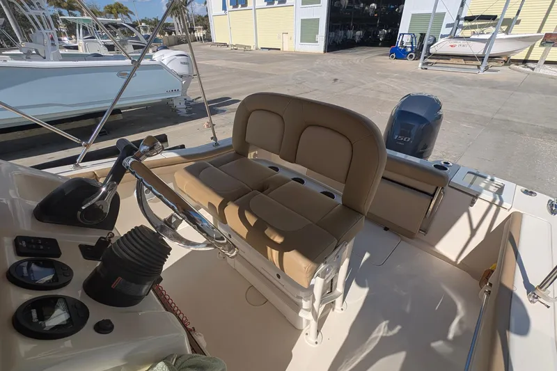 Slide: The Image of 2019 Scout 215 XSF boat interior with steering wheel and seating. - 23