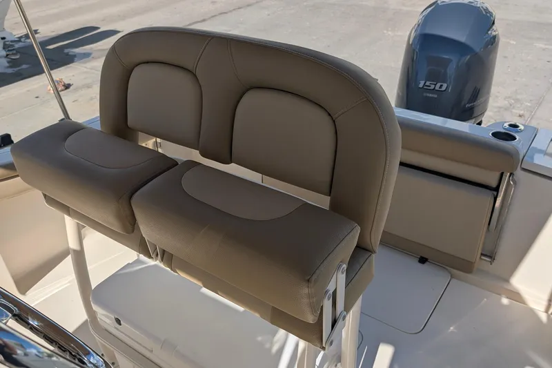 Slide: The Image of 2019 Scout 215 XSF boat interior with cushioned seating and Yamaha 150 outboard motor. - 24