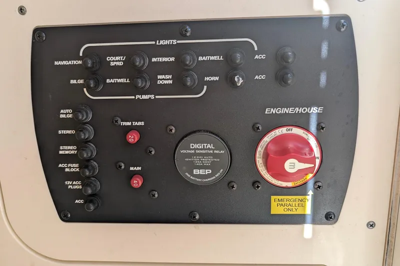 Slide: The Image of Control panel of a 2019 Scout 215 XSF boat with various switches and dials. - 30