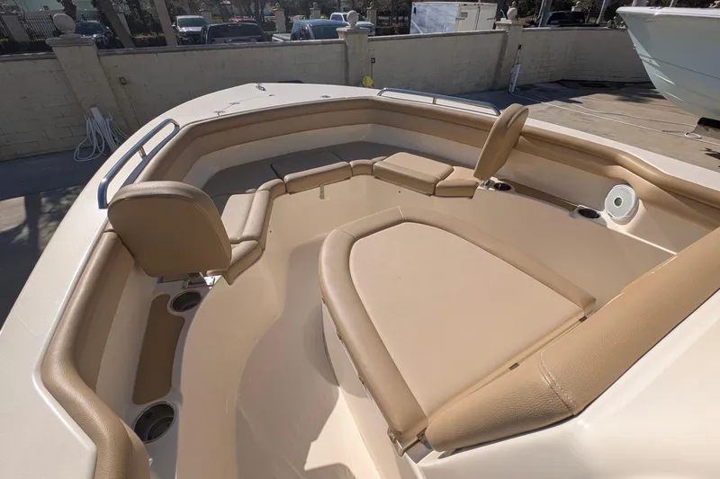 Slide: The Image of 2019 Scout 215 XSF boat interior with tan seating and cup holders. - 31