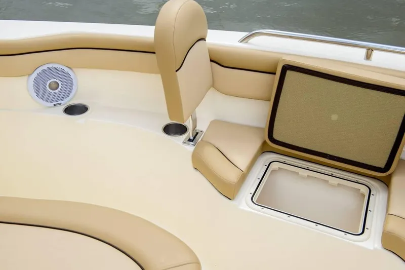 Slide: The Image of 2019 Scout 215 XSF boat interior with beige seating and storage compartment. - 33