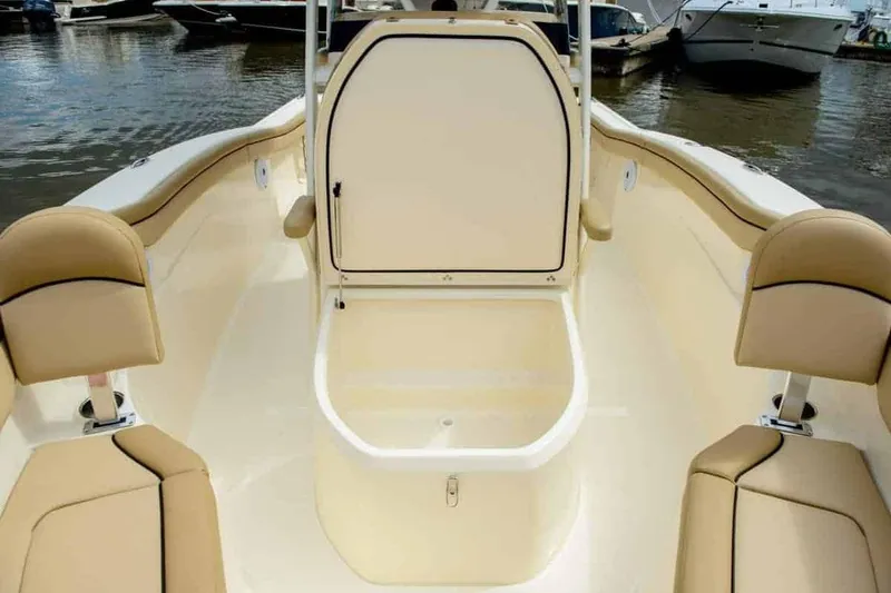 Slide: The Image of 2019 Scout 215 XSF boat interior with beige seating and storage compartment. - 36