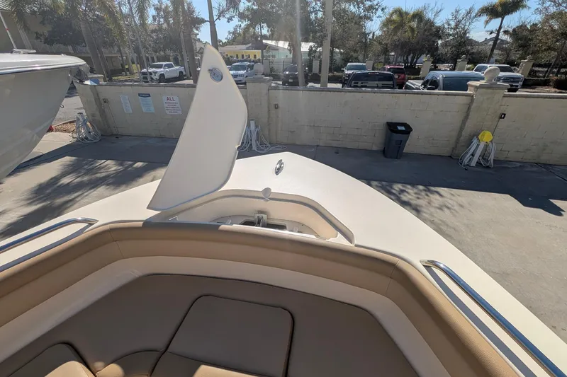 Slide: The Image of 2019 Scout 215 XSF boat interior with open hatch, parked outdoors. - 37