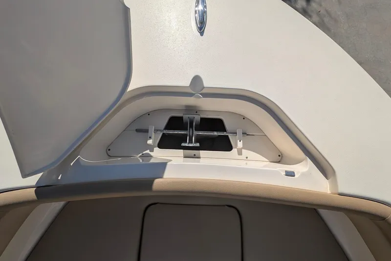 Slide: The Image of 2019 Scout 215 XSF boat anchor storage compartment, open lid view. - 38