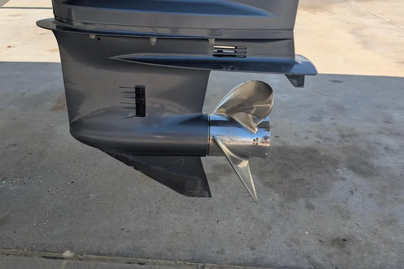 Slide: The Image of Close-up of a 2019 Scout 215 XSF boat propeller on concrete surface. - 40