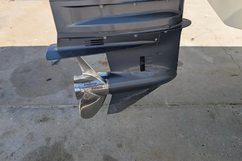 Slide: The Image of Outboard motor propeller of a 2019 Scout 215 XSF boat on concrete surface. - 41