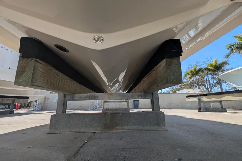 Slide: The Image of 2019 Scout 215 XSF boat hull on a support stand, outdoor storage area. - 42