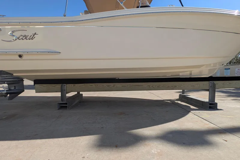 Slide: The Image of 2019 Scout 215 XSF boat on a trailer, side view under bright sunlight. - 43