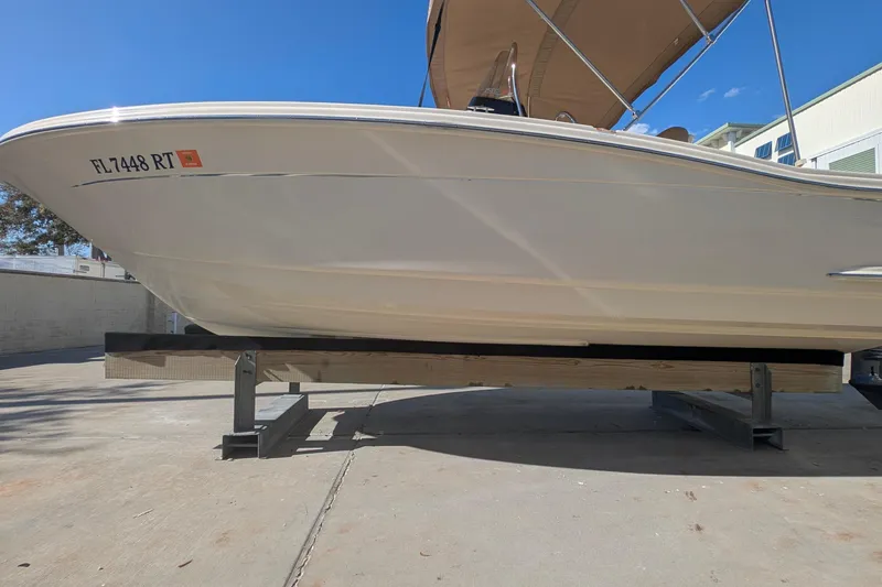 Slide: The Image of 2019 Scout 215 XSF boat on a lift, sunny day, registration FL 7448 RT. - 44