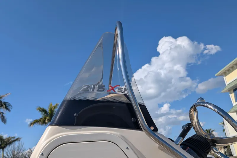 Slide: The Image of 2019 Scout 215 XSF boat console against a clear blue sky with clouds. - 5