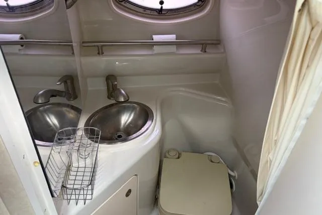 Slide: The Image of Compact bathroom in 2008 Sea Ray 240 Sundancer boat with sink and toilet. - 12