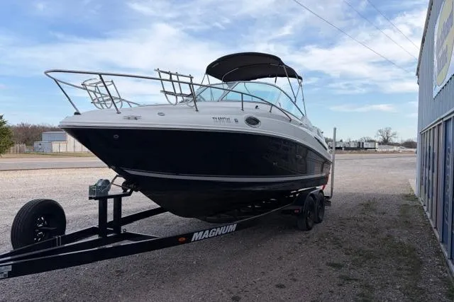 Slide: The Image of 2008 Sea Ray 240 Sundancer boat on trailer, parked outdoors under a clear sky. - 3