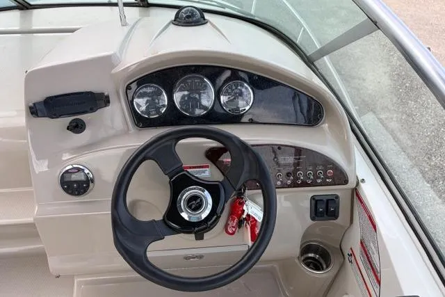 Slide: The Image of 2008 Sea Ray 240 Sundancer dashboard with steering wheel and instrument panel. - 6