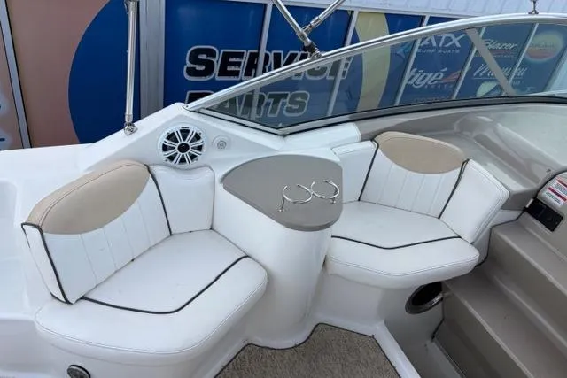 Slide: The Image of 2008 Sea Ray 240 Sundancer boat interior with white seating and cup holders. - 7