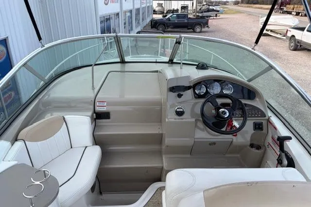 Slide: The Image of 2008 Sea Ray 240 Sundancer boat cockpit with steering wheel and seating area. - 8