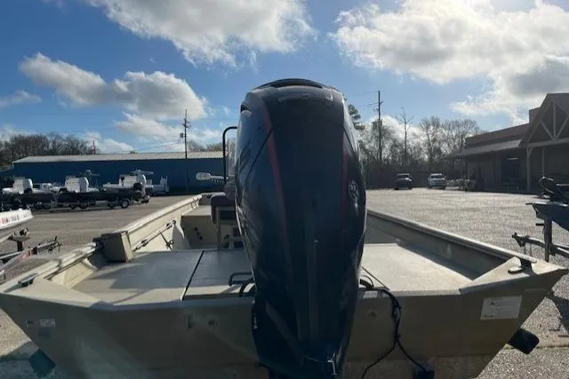 Slide: The Image of 2017 Crestliner 2070 Retriever CC boat with outboard motor in a sunny parking lot. - 6