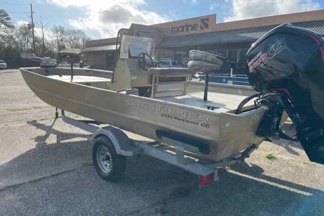 Slide: The Image of 2017 Crestliner 2070 Retriever CC boat on trailer, parked outside marine store. - 8