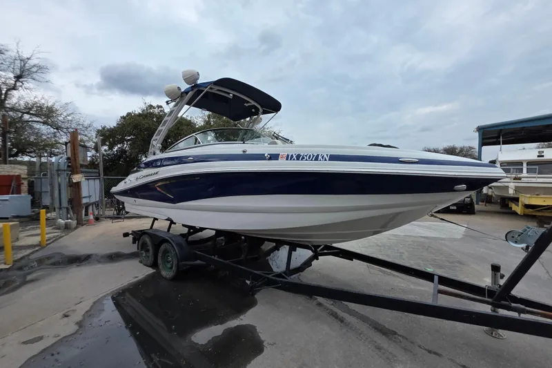 Slide: The Image of 2022 Crownline Eclipse E255 boat on trailer, parked outdoors. - 61