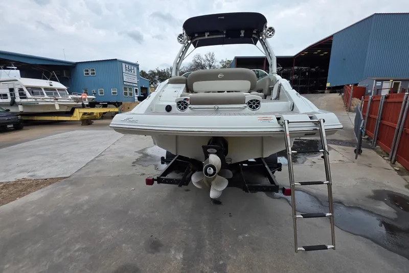 Slide: The Image of 2022 Crownline Eclipse E255 boat with ladder, docked at a marina. - 65