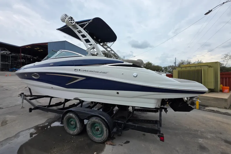 Slide: The Image of 2022 Crownline Eclipse E255 boat on trailer, parked outdoors. - 67