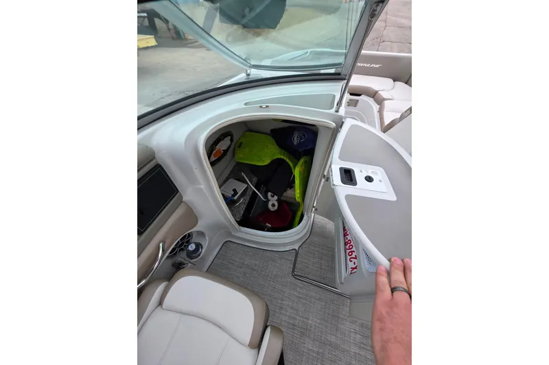 Slide: The Image of 2022 Crownline Eclipse E255 boat interior storage compartment open. - 70