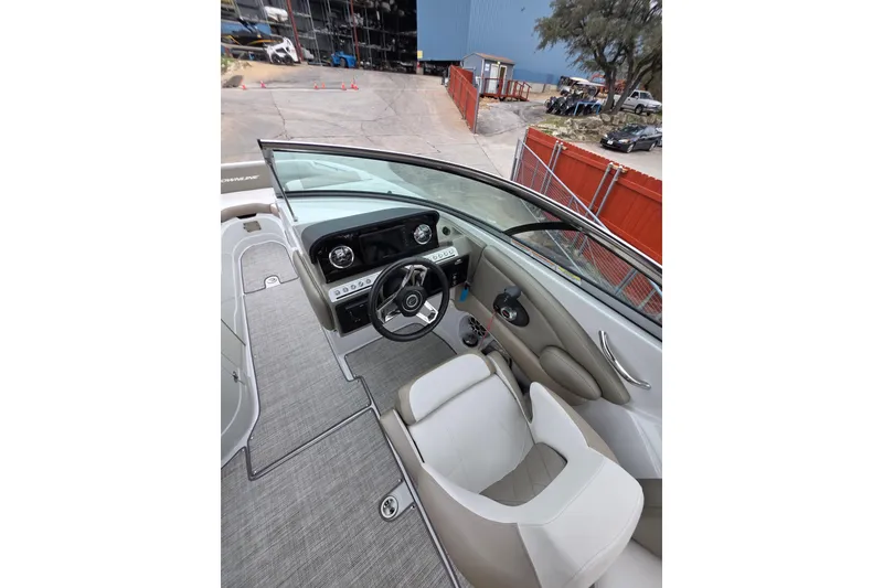 Slide: The Image of 2022 Crownline Eclipse E255 boat interior with steering wheel and dashboard view. - 76