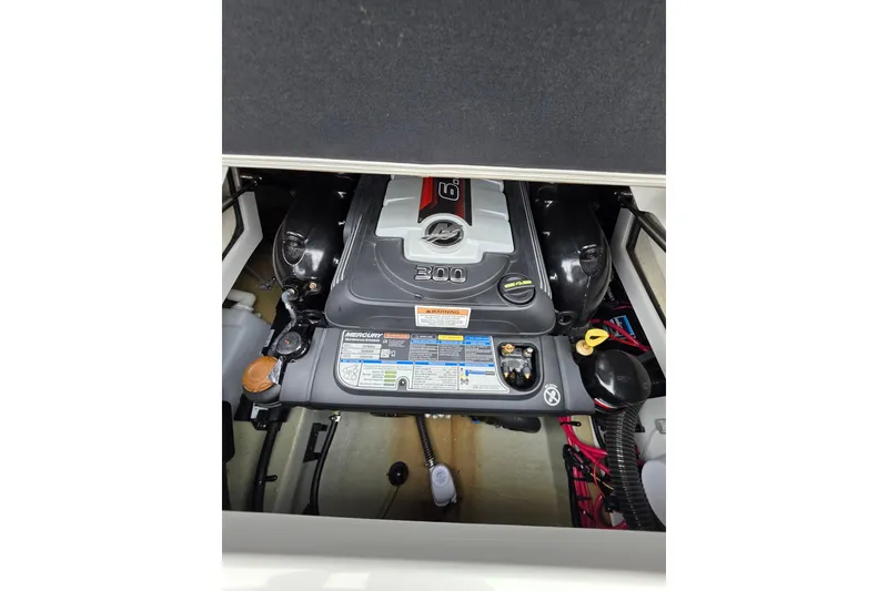Slide: The Image of Engine compartment of 2022 Crownline Eclipse E255 boat, featuring a Mercury 300 engine. - 77