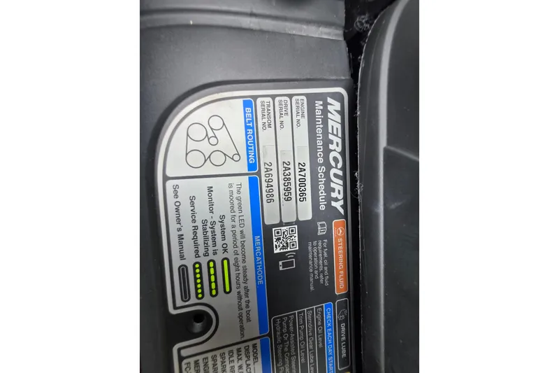 Slide: The Image of Label on Mercury engine showing maintenance schedule and belt routing for Crownline Eclipse E255. - 79