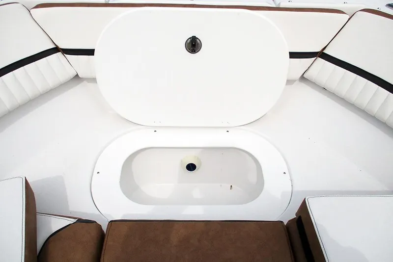 Slide: The Image of 2026 Stingray 20 SBX boat interior with storage compartment and cushioned seating. - 10