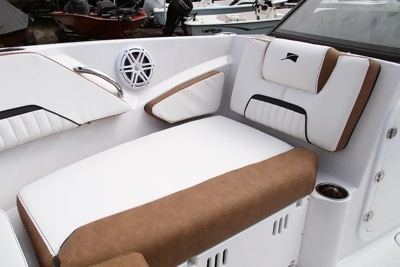 Slide: The Image of 2026 Stingray 20 SBX boat interior with white and brown cushioned seating. - 12