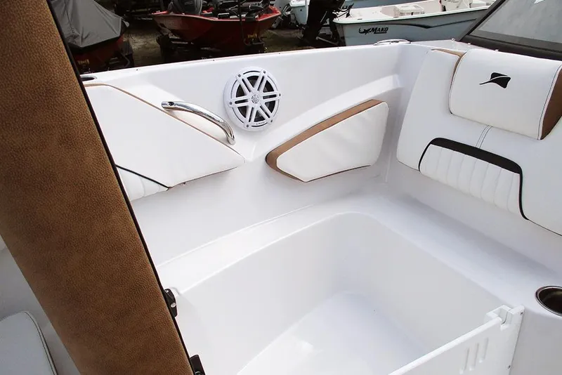 Slide: The Image of 2026 Stingray 20 SBX boat interior with white and brown seating, speaker, and sleek design. - 13