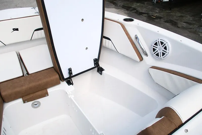 Slide: The Image of 2026 Stingray 20 SBX boat interior with open storage compartment and speaker. - 14