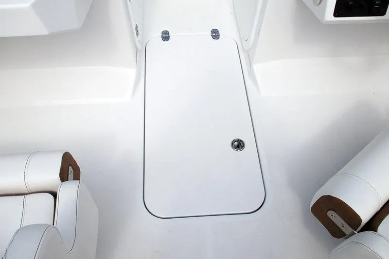 Slide: The Image of 2026 Stingray 20 SBX boat interior with white seating and storage compartment. - 18
