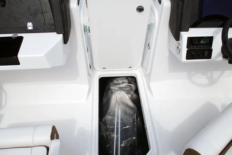 Slide: The Image of 2026 Stingray 20 SBX boat interior with storage compartment and control panel. - 19