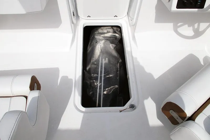 Slide: The Image of 2026 Stingray 20 SBX boat interior storage compartment with white seating. - 20