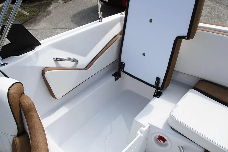 Slide: The Image of 2026 Stingray 20 SBX boat interior with white and brown seating and storage compartment. - 25