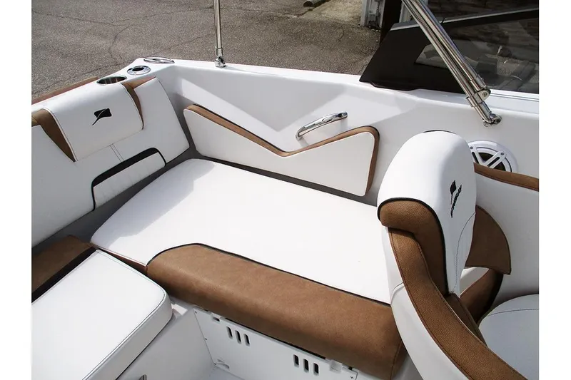 Slide: The Image of 2026 Stingray 20 SBX boat interior with white and brown cushioned seating. - 26
