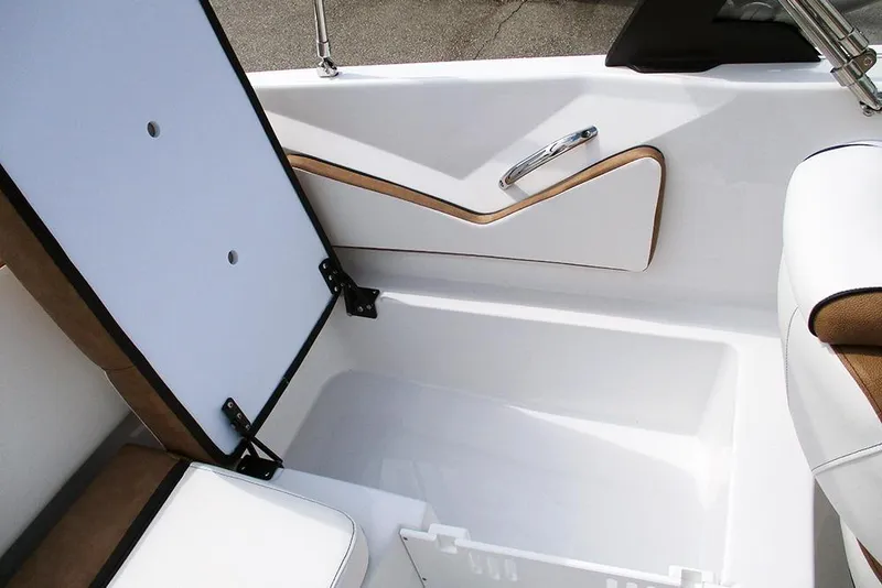 Slide: The Image of 2026 Stingray 20 SBX boat interior storage compartment with white and brown accents. - 27