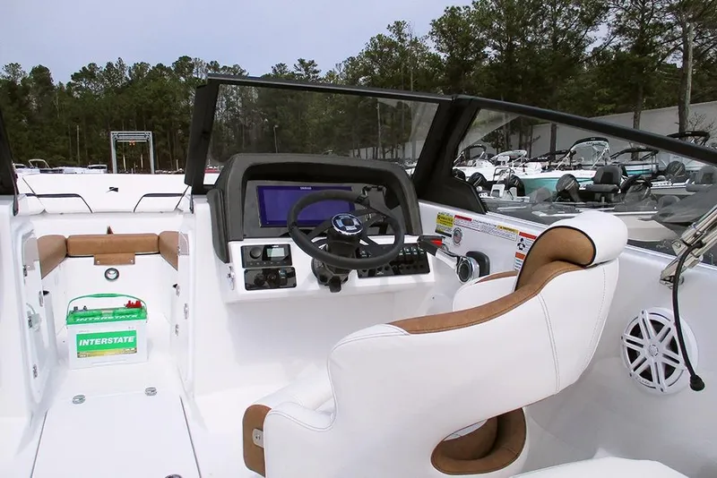 Slide: The Image of 2026 Stingray 20 SBX boat interior with steering wheel and control panel. - 28
