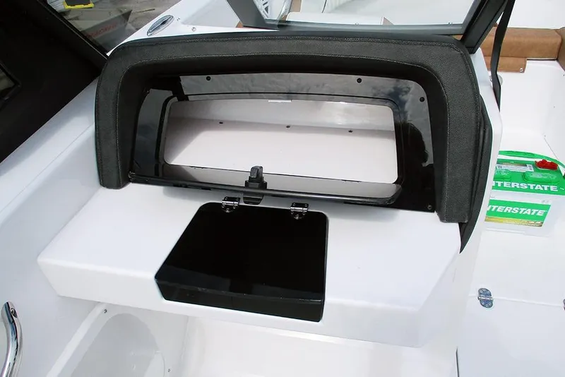 Slide: The Image of 2026 Stingray 20 SBX boat dashboard with storage compartment open. - 30
