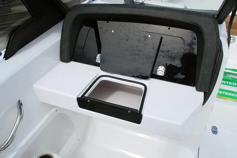 Slide: The Image of 2026 Stingray 20 SBX boat interior with sleek dashboard and storage compartment. - 31
