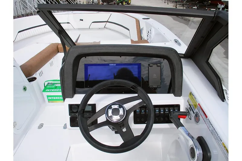 Slide: The Image of 2026 Stingray 20 SBX boat dashboard with steering wheel and control panel. - 32