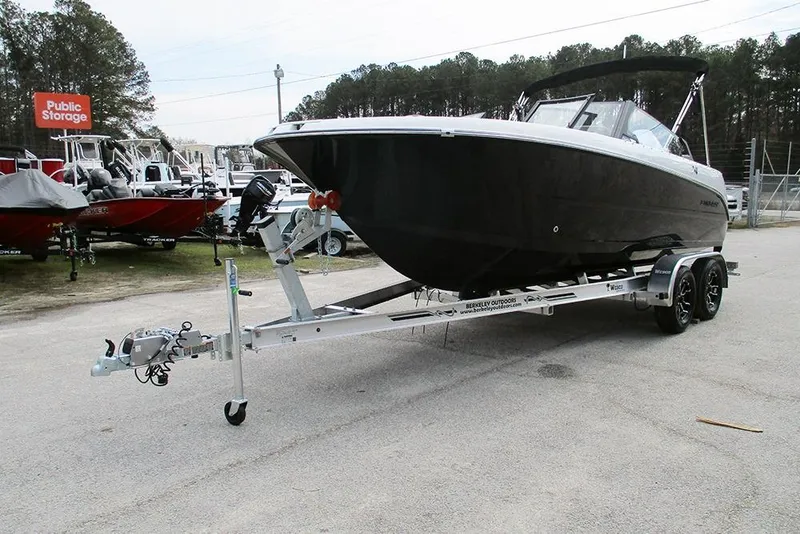 Slide: The Image of 2026 Stingray 20 SBX boat on trailer in outdoor storage area. - 4