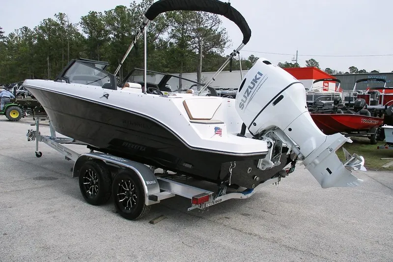 Slide: The Image of 2026 Stingray 20 SBX boat on trailer with Suzuki outboard motor. - 6