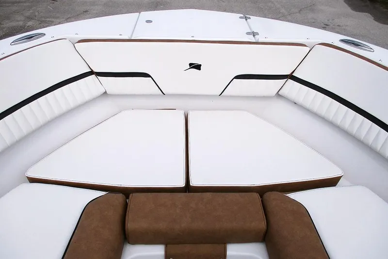 Slide: The Image of 2026 Stingray 20 SBX boat interior with white and brown cushioned seating. - 8