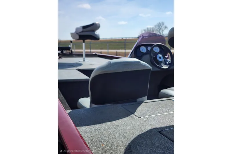 Slide: The Image of 2018 Tracker Pro 170 boat interior with steering wheel and seating, under clear blue sky. - 8