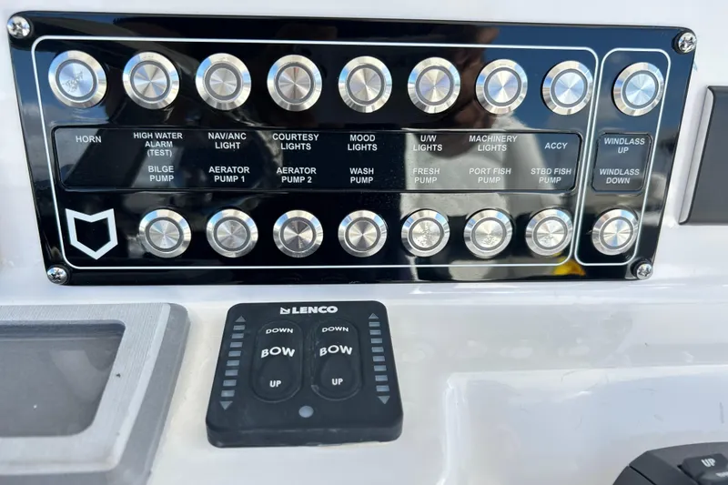 Slide: The Image of Control panel of 2026 Sea Fox 288 Commander boat with labeled buttons and switches. - 11