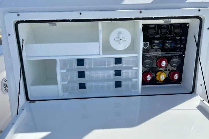 Slide: The Image of 2026 Sea Fox 288 Commander storage compartment with organized shelves and control panel. - 17